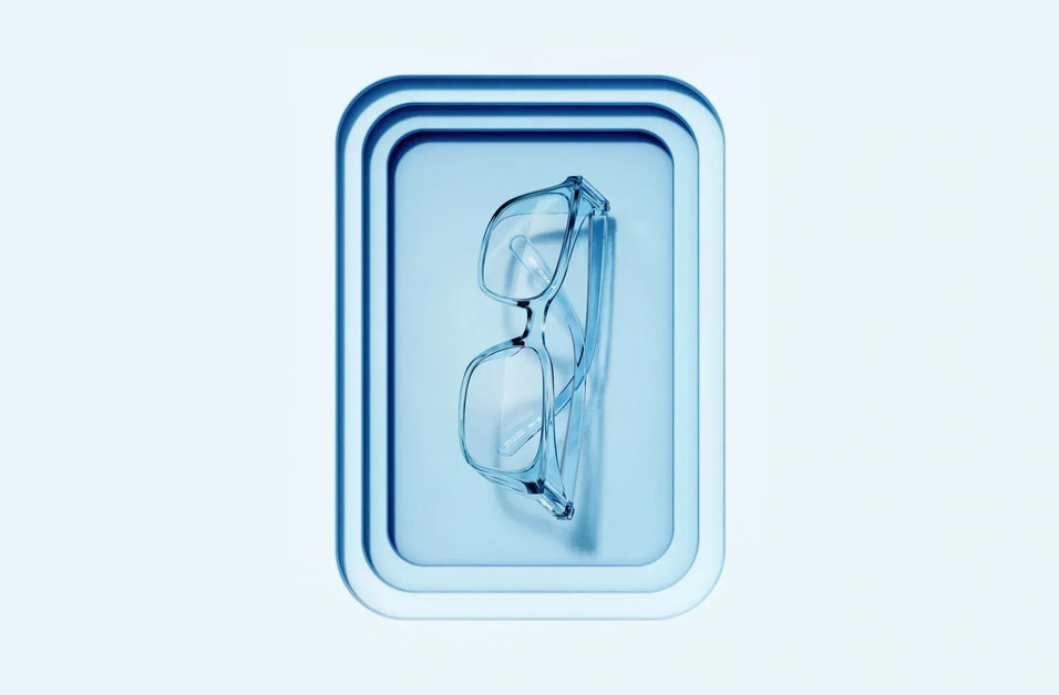 Denim Blue Stoggles ANSI Z87.1-certified safety glasses displayed on a matching blue tray against a monochromatic blue background.