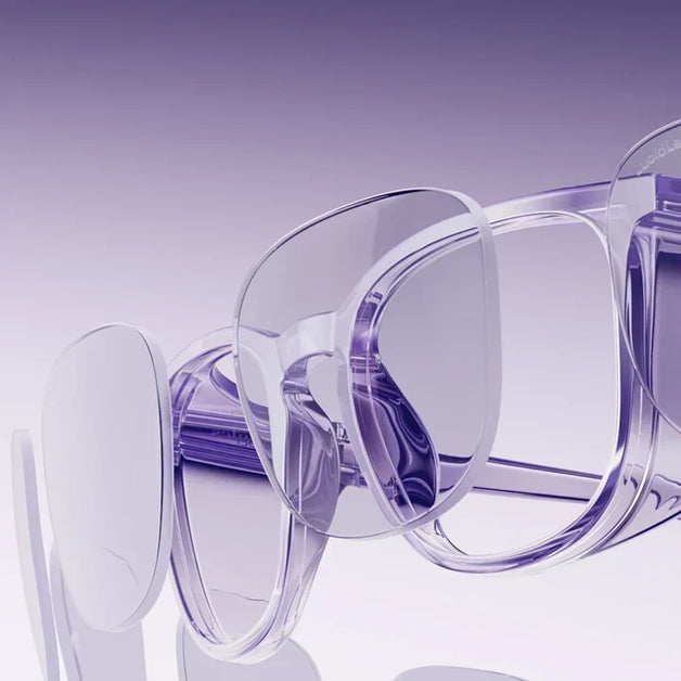  Clear eyeglasses with purple-tinted frames from Stoggles displayed in a row on a purple gradient background.