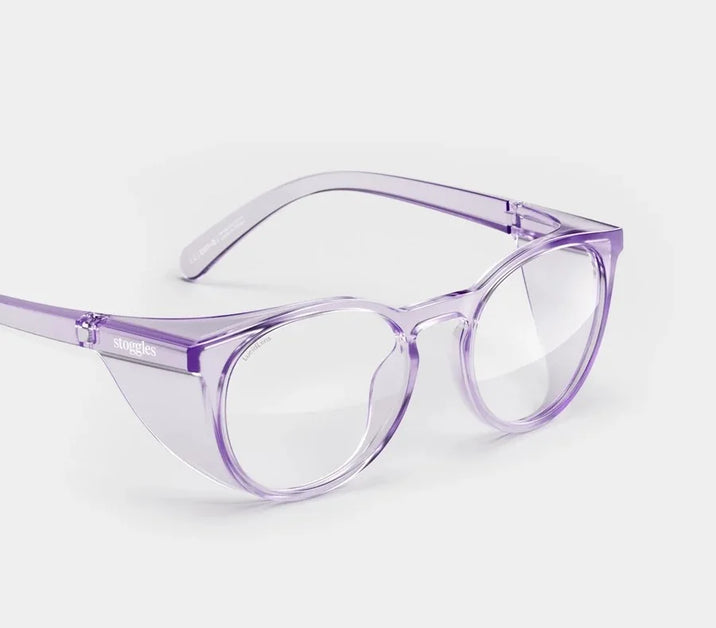 Translucent lilac safety glasses from Stoggles with round frames and side shields on a white background.