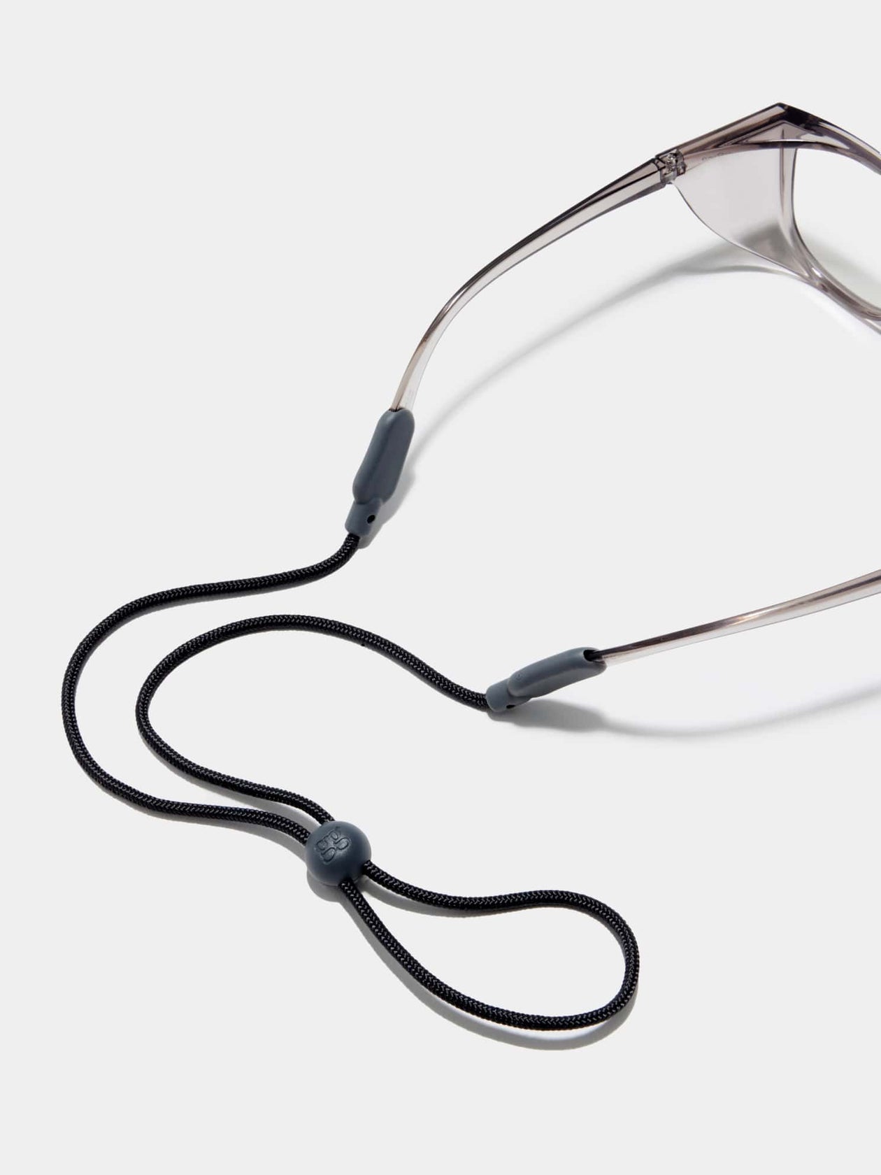 Adjustable Stoggles eyewear strap attached to protective glasses, designed to keep frames secure during work, sports, and everyday activities.